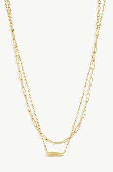 Two gold necklaces on a white background. One gold necklace is a larger chain while the other is a smaller chain.
