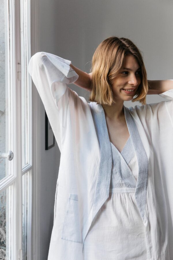 Woman wearing robe in white and blue trim