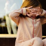 Kid wearing red and white pajama set