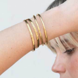 gold bangles on wrist