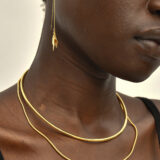 person wearing gold necklace