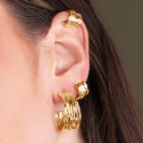 person wearing gold hoop earrings