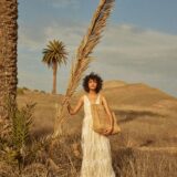 person carrying raffia tote