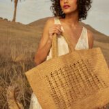 person holding raffia tote