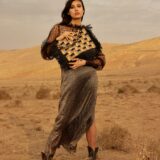 person carrying raffia bag