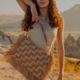 person carrying raffia bag