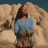 person carrying seven raffia bags