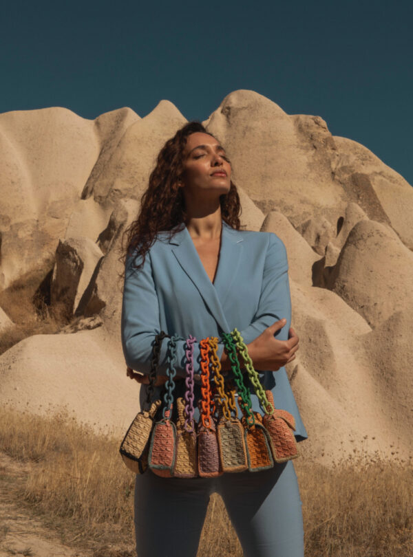 person carrying seven raffia bags