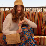 person carrying raffia bag