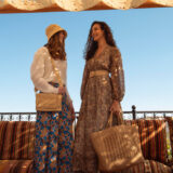 two people carrying raffia bag